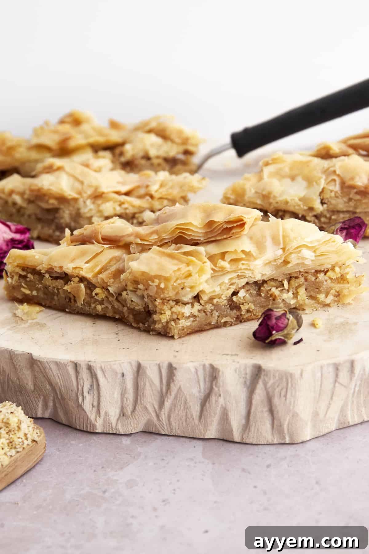 A close-up of a beautifully layered easy baklava, glistening with honey syrup and crushed nuts.