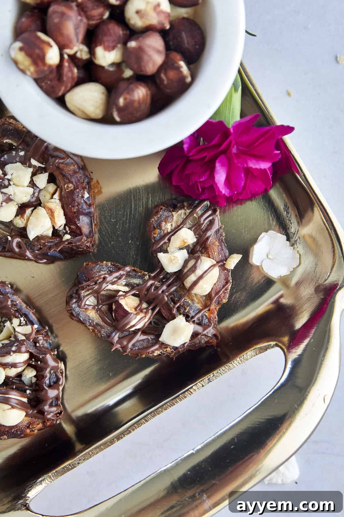 A beautifully shaped hazelnut-stuffed heart-shaped date, symbolizing love.