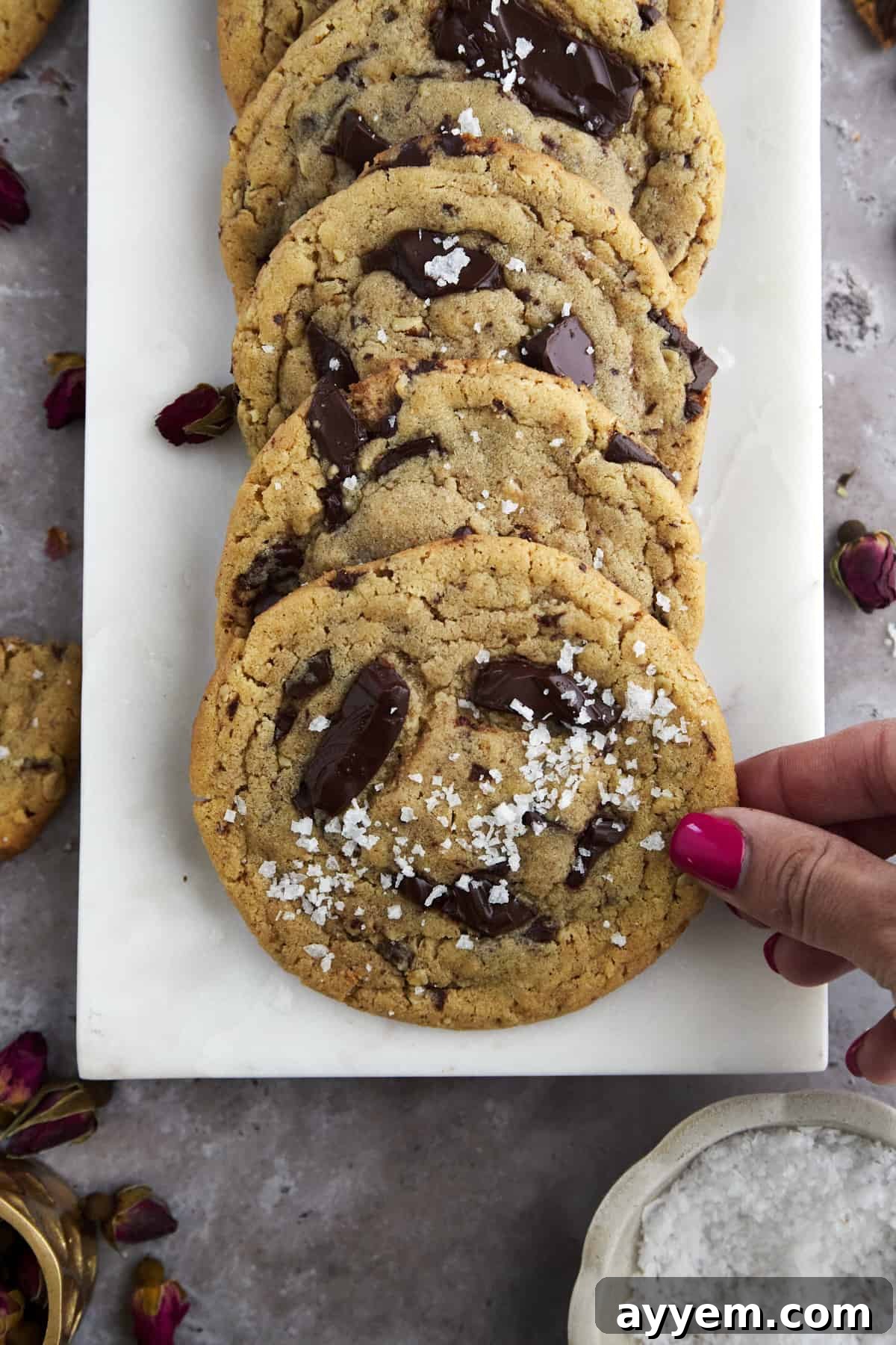 A rustic plate of tahini chocolate chip cookies, showcasing their golden-brown edges and soft centers.