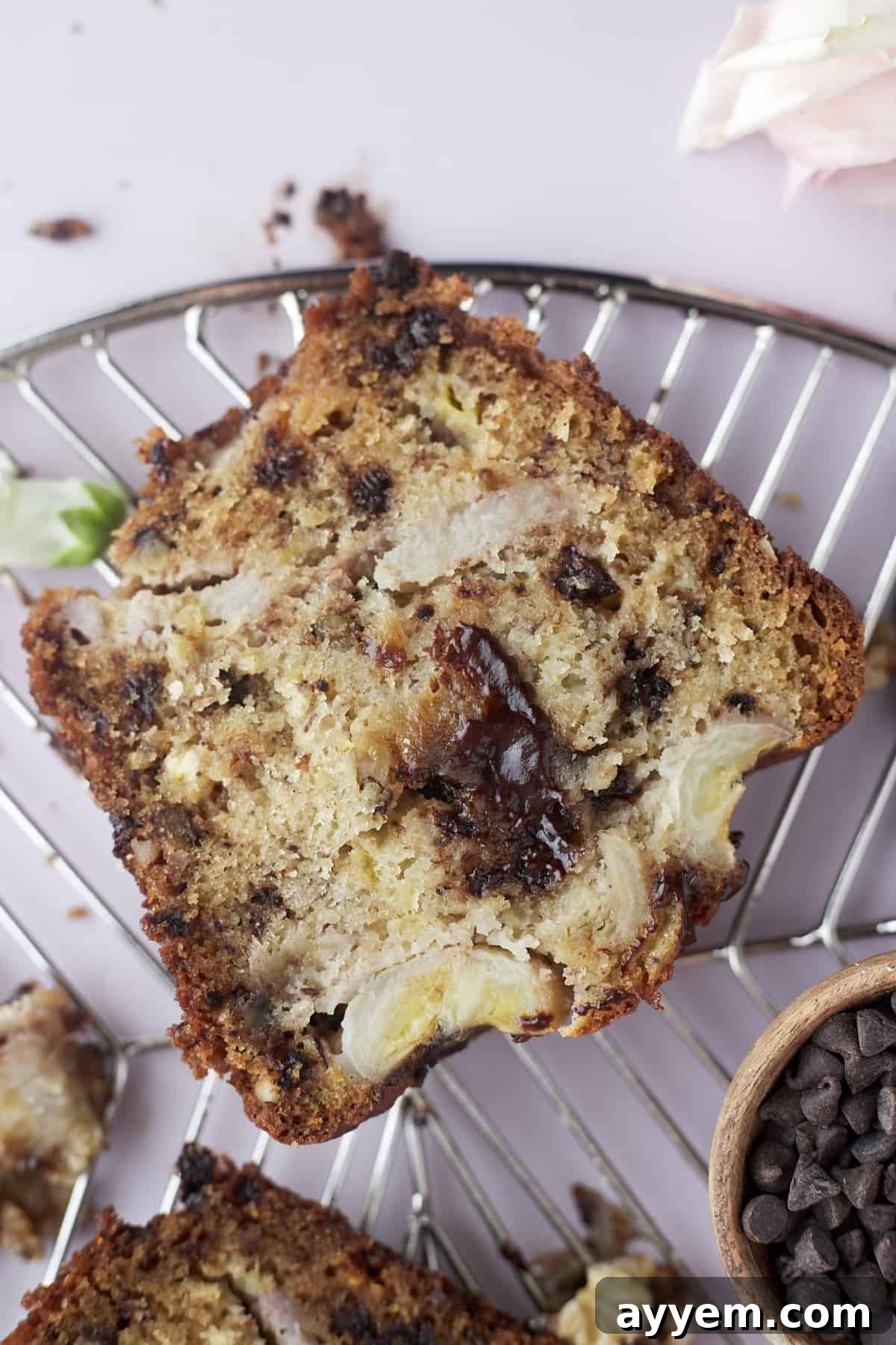 A loaf of decadent chocolate chip walnut banana bread, freshly baked and sliced.