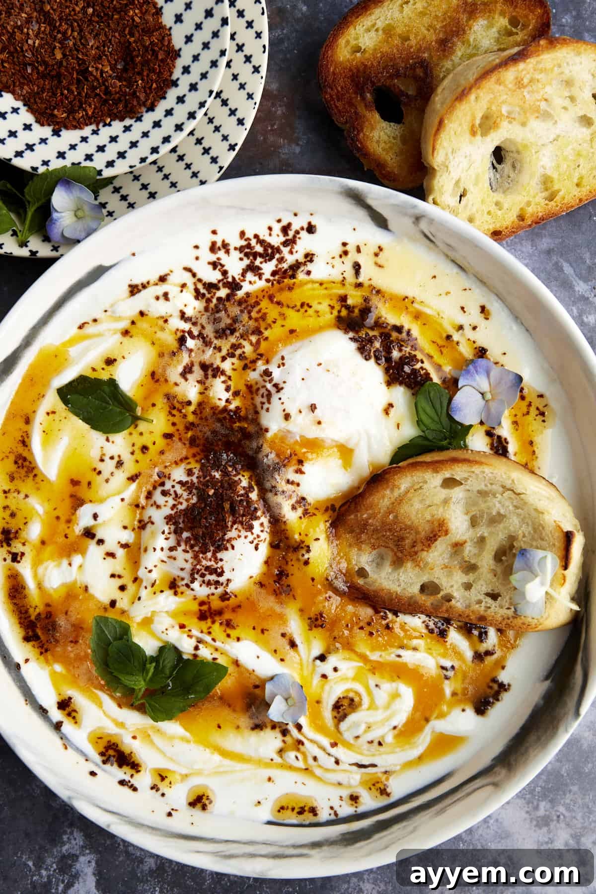 Anatolian Poached Eggs with Cottage Cheese 2 Overhead image of a bowl of Turkish poached eggs with cottage cheese. A perfect breakfast or brunch.