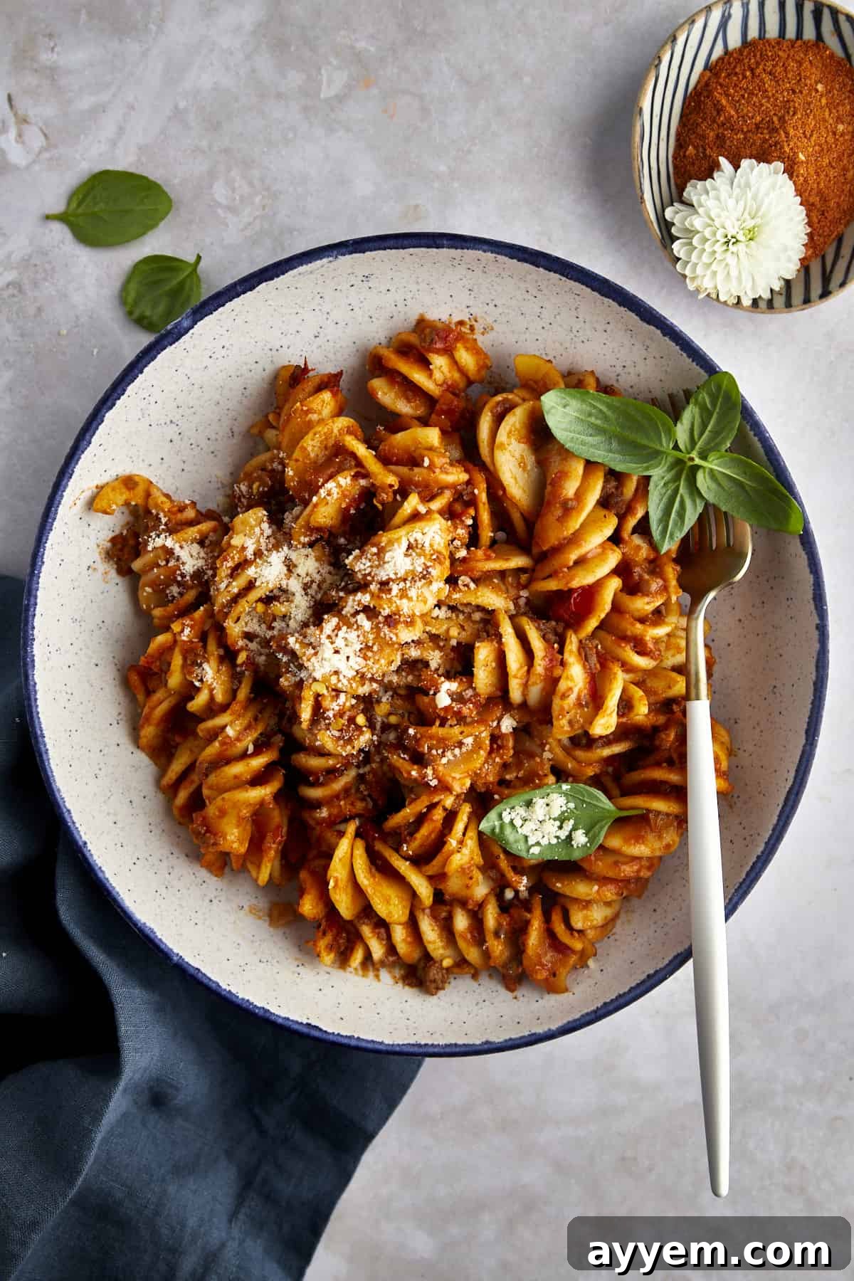 Overhead image of a bowl of taco pasta with a fork on the side. 