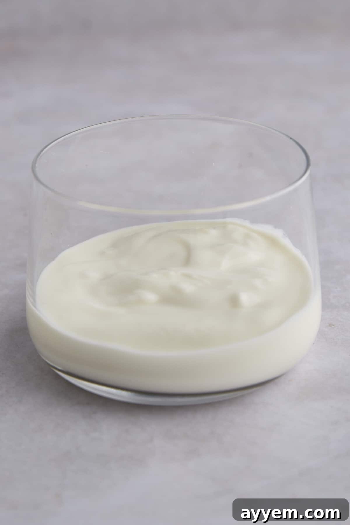 Yogurt layered in a jar, showcasing the creamy base of a fruit and yogurt parfait.