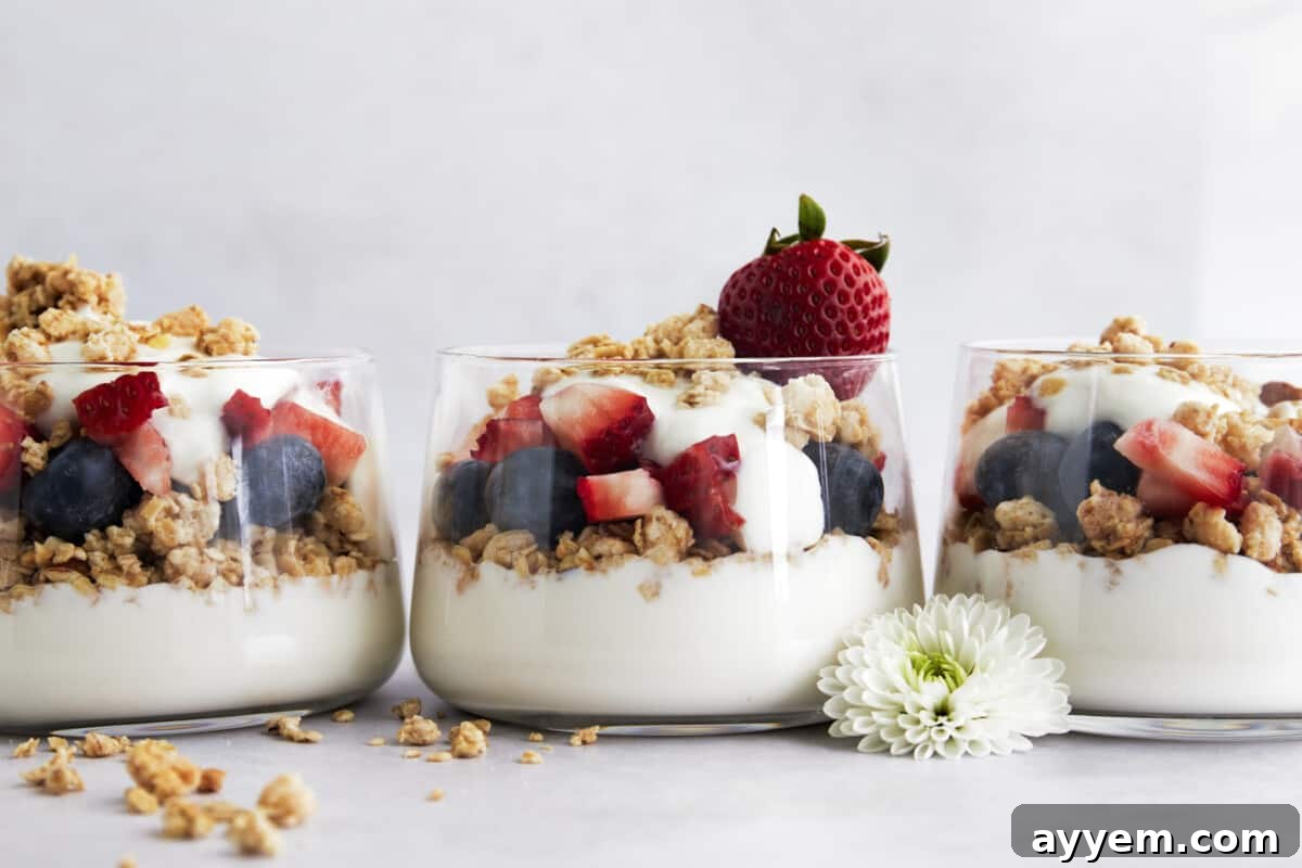 Three jars full of fruit and yogurt parfaits, prepared for a healthy and quick breakfast.