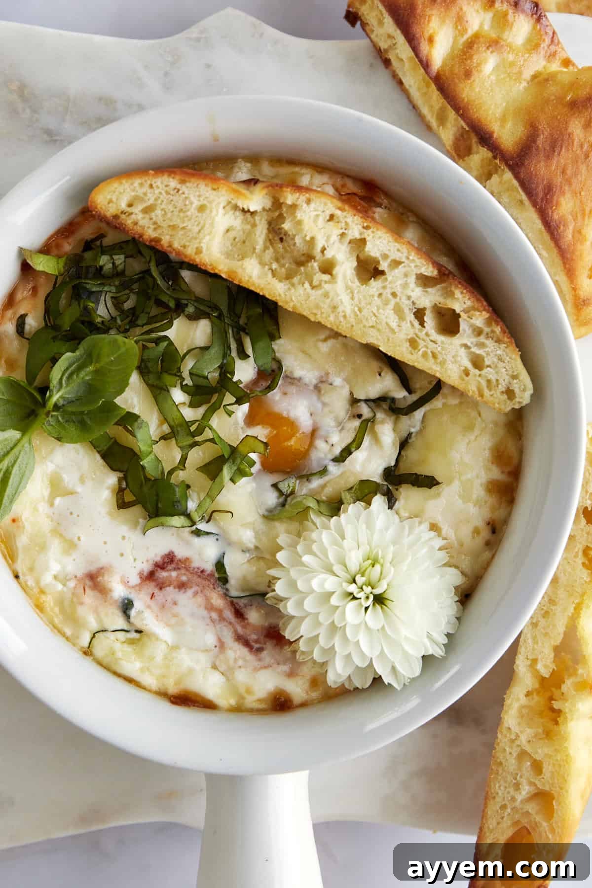 Easy Italian Baked Eggs Purgatorio 3 A ramekin of Eggs in Purgatory with a piece of bread on top.