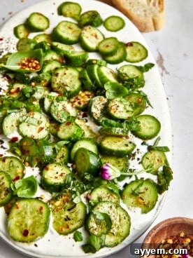 Fresh and creamy cucumber cottage cheese dip, garnished with herbs, served with crisp vegetables