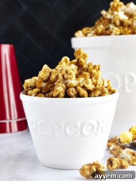A small bowl overflowing with golden, crunchy homemade caramel popcorn, perfect for snacking