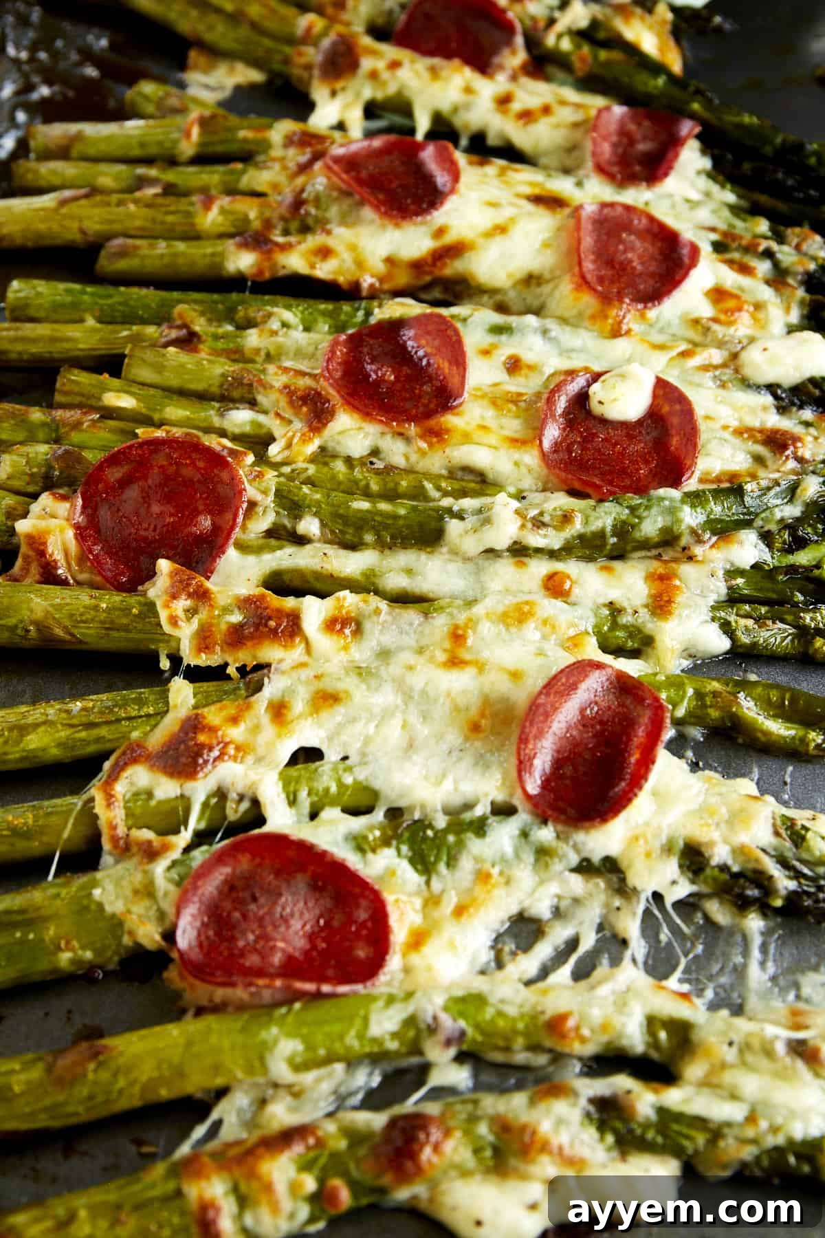 Pizza-flavored oven baked asparagus topped with pepperoni. 