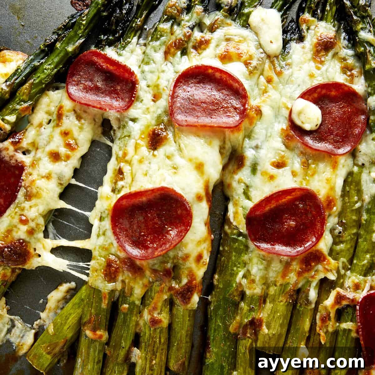 Pizza-flavored oven baked asparagus topped with pepperoni.