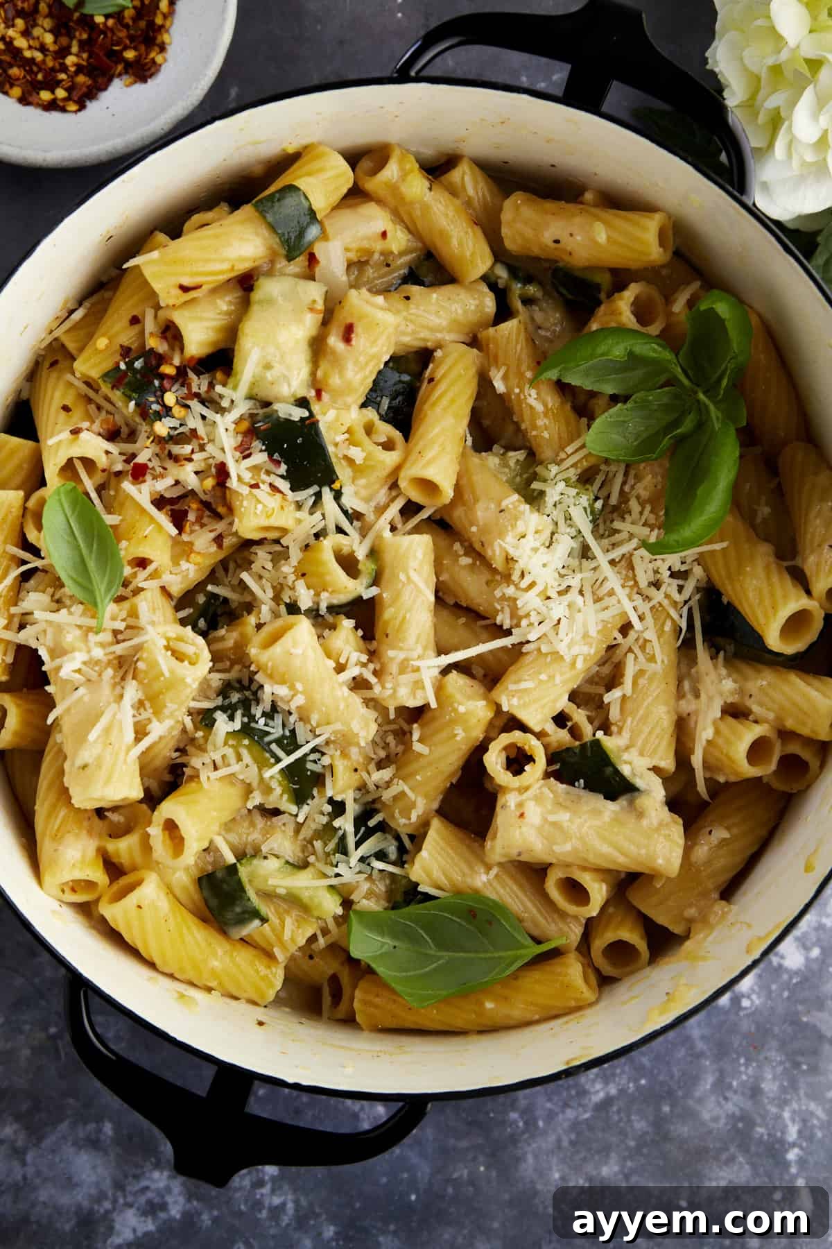 Overhead image of a pot of pasta with zucchini.