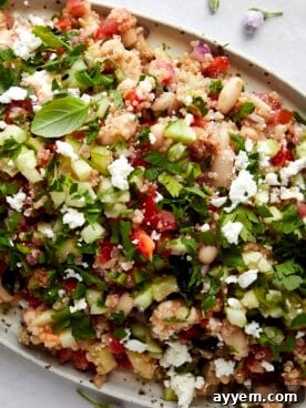 Vibrant Quinoa Cannellini Bean Salad with fresh herbs and cherry tomatoes on a serving platter.