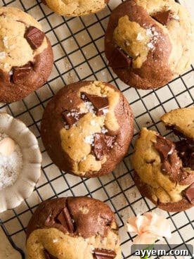 Irresistible Brown Butter Brookies Cookies with visible chocolate chunks and sea salt flakes on a cooling rack.