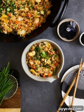 A vibrant bowl of quick and easy wok egg fried rice with crisp vegetables, a perfect homemade takeout alternative.