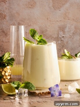 A refreshing glass of authentic Egyptian Mint Lemonade (Limonana) garnished with fresh mint leaves and a lemon slice.