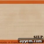 Silpat mat with an orange border.