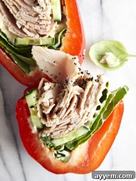 Two halves of a sliced low-carb turkey bell pepper sandwich.