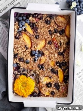 Overhead image of peach blueberry baked oats in a baking dish.