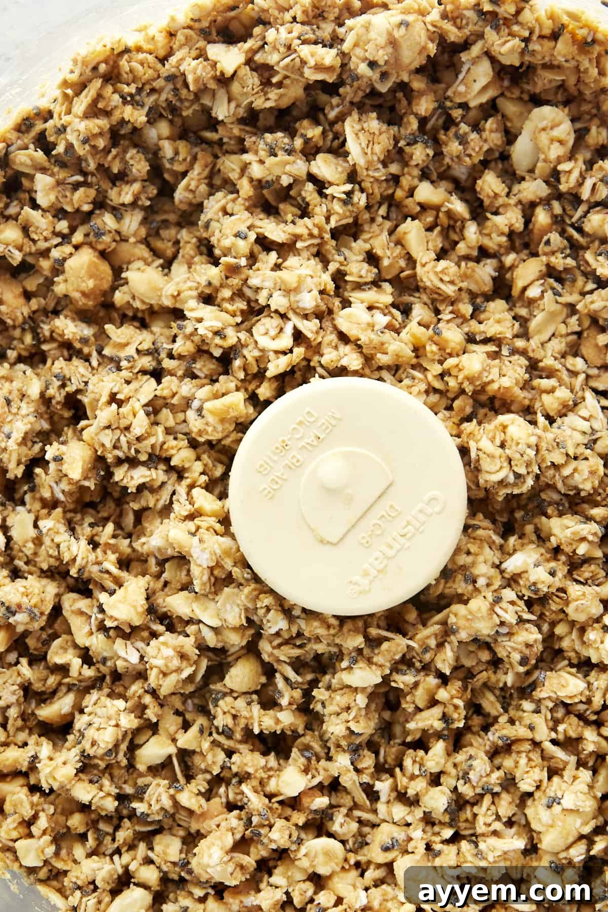 Ingredients for the oat cup filling being blended in a food processor to create a sticky, cohesive mixture.