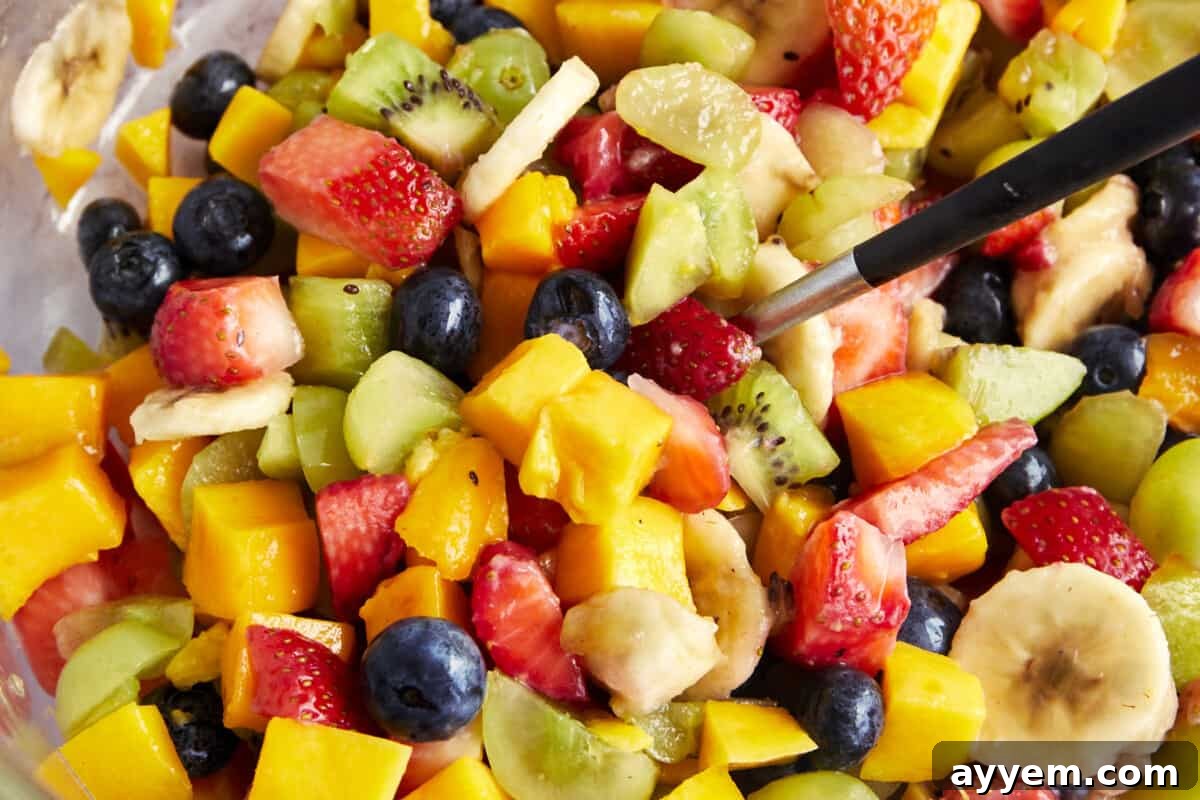 A close-up view of a colorful assortment of freshly chopped fruits, ready to be mixed for Fakhfakhina.