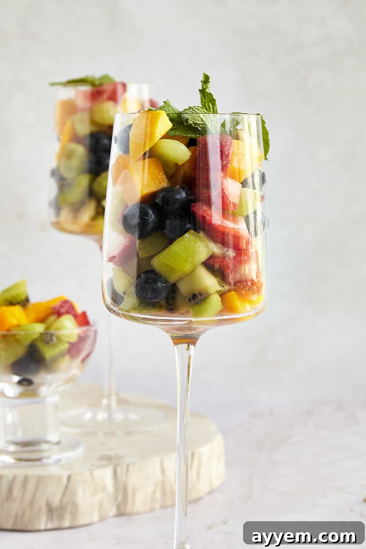 A vibrant Fakhfakhina drink in a glass, showcasing a rich blend of fresh fruits and juice, topped with whipped cream.