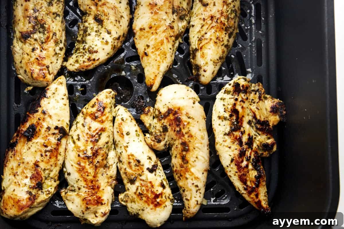 Cooked lime chicken in an air fryer basket. 