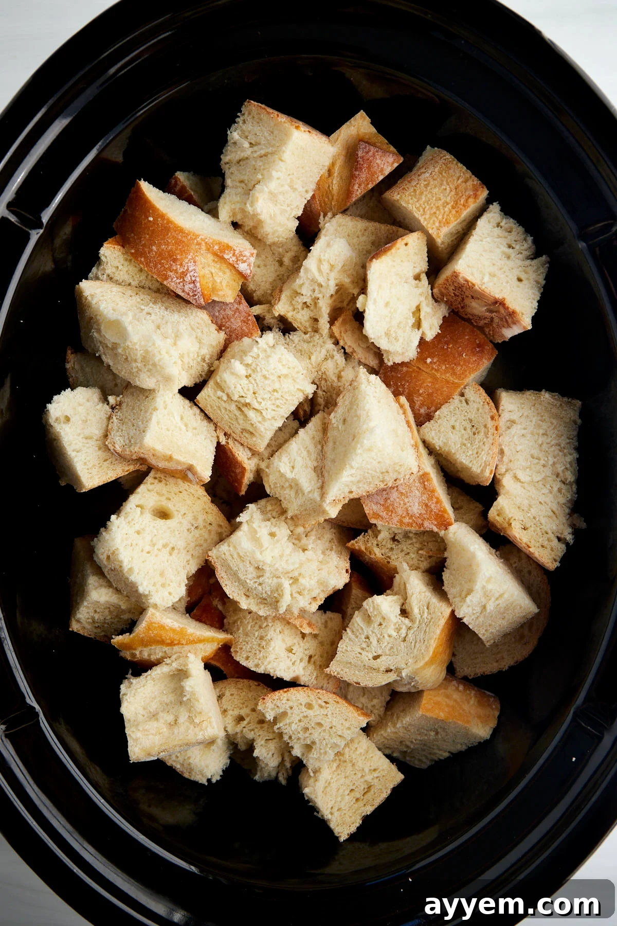 Cubed pieces of bread in a crockpot. 