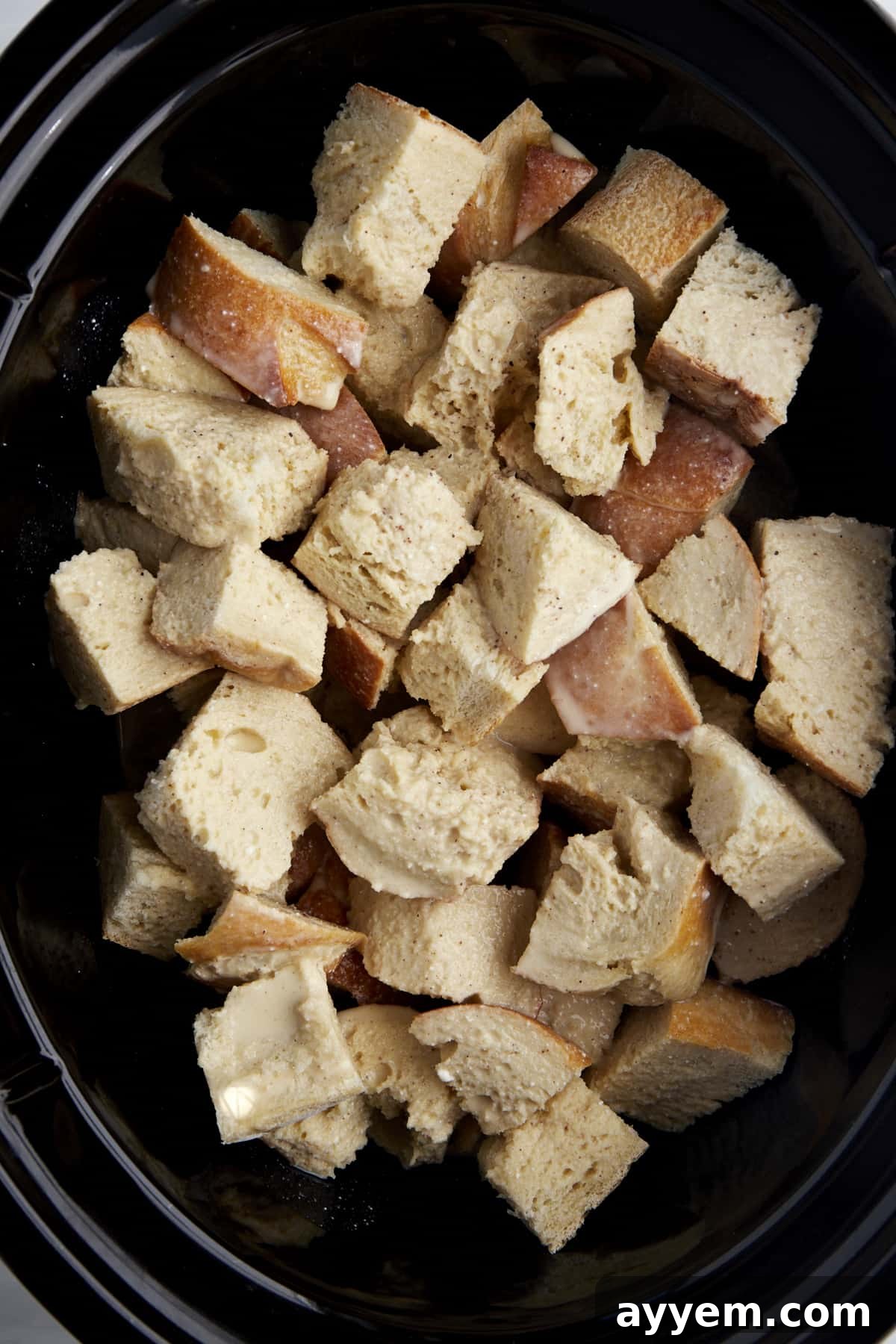 Cubed pieces of bread in a crockpot. 