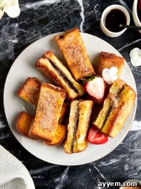 Cinnamon sugar Nutella French toast sticks on a plate.