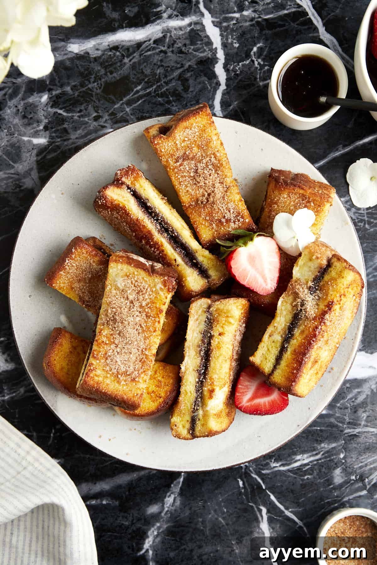 Overhead image of cinnamon sugar Nutella French toast sticks on a plate. 