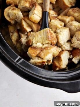 A warm, inviting crockpot French toast casserole, ready to be scooped, perfect for a festive breakfast or brunch.