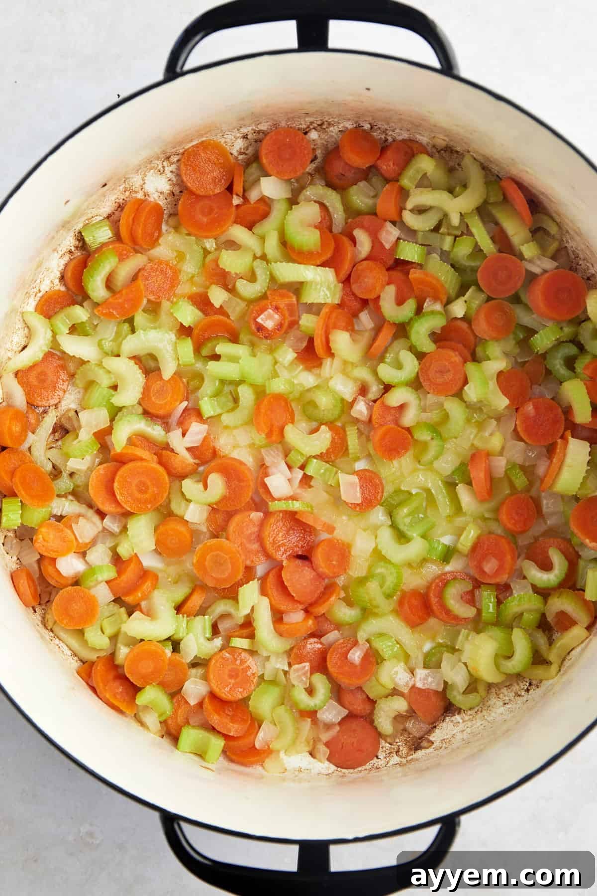 Chopped carrots, onions, and celery in a soup pot with butter and oil. 