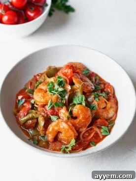Overhead view of shrimp and tomato sauce on a plate.