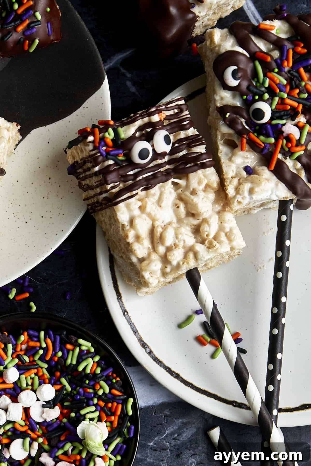 Halloween rice krispie treats with paper straws sticking out.