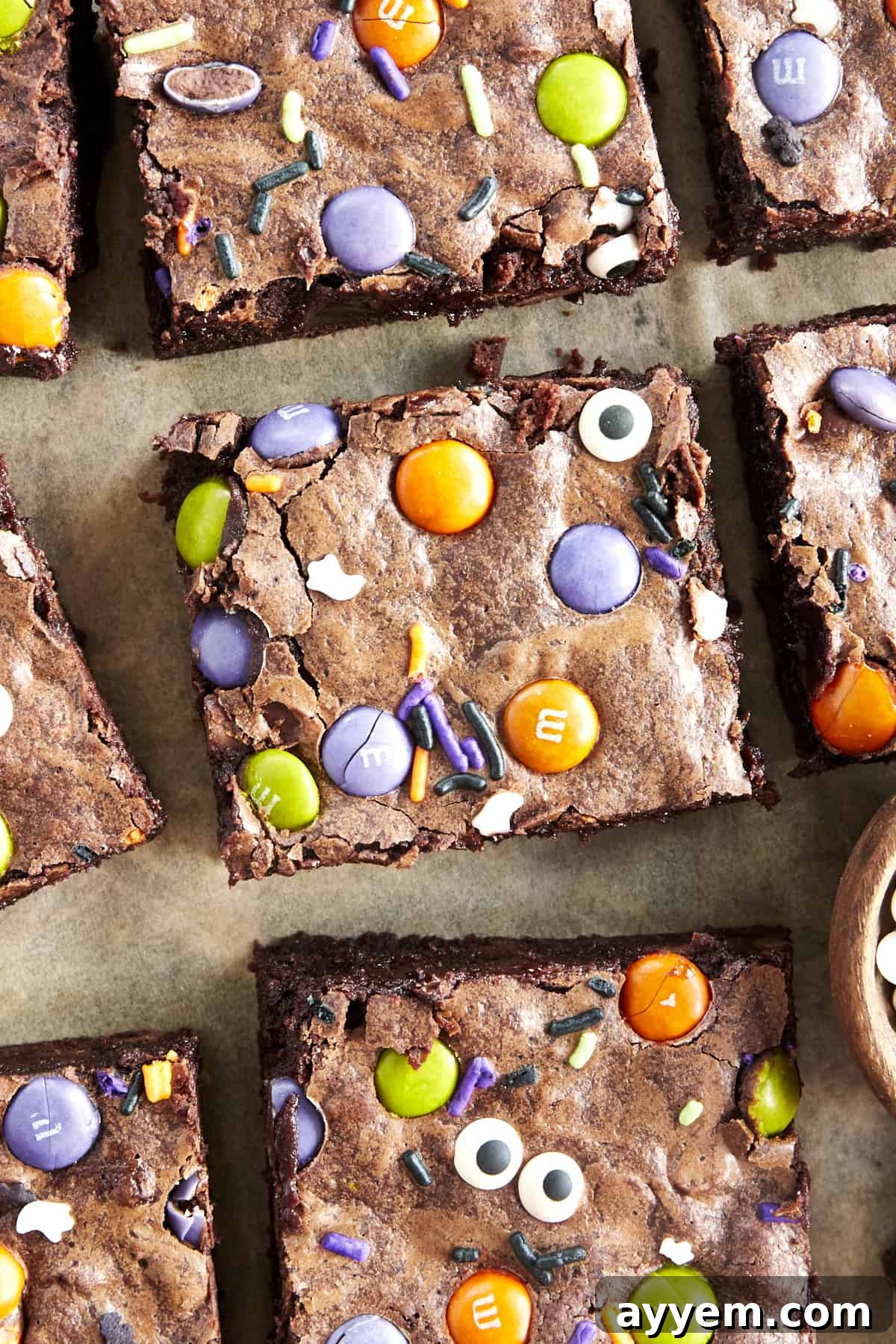 Square Halloween brownies on parchment paper. 