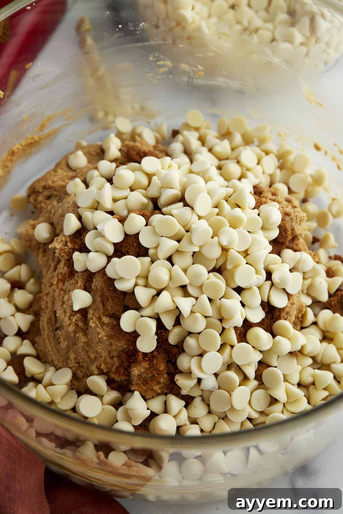 Biscoff cookie dough studded with white chocolate chips, ready for baking.