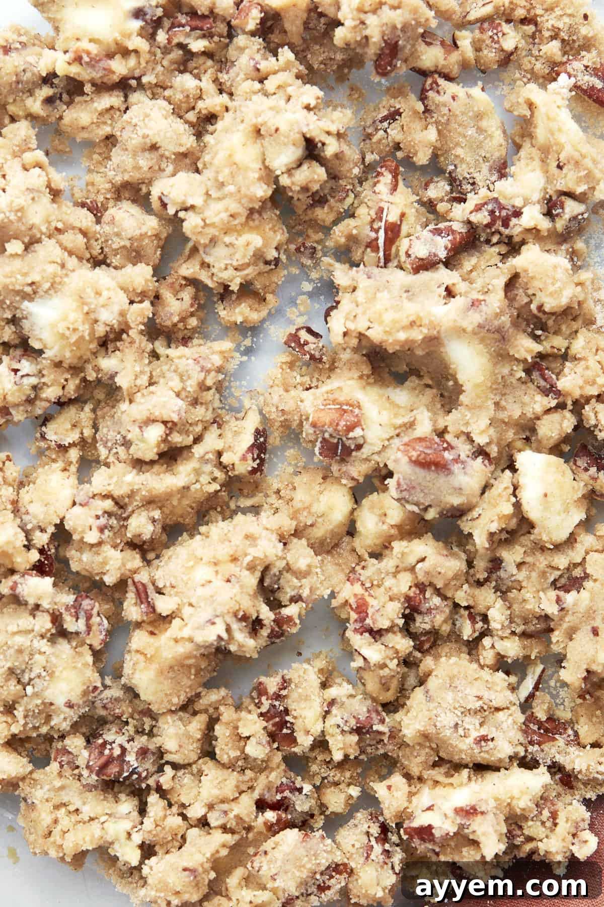 A close-up of the crumbly streusel topping with chopped nuts, ready to be sprinkled.