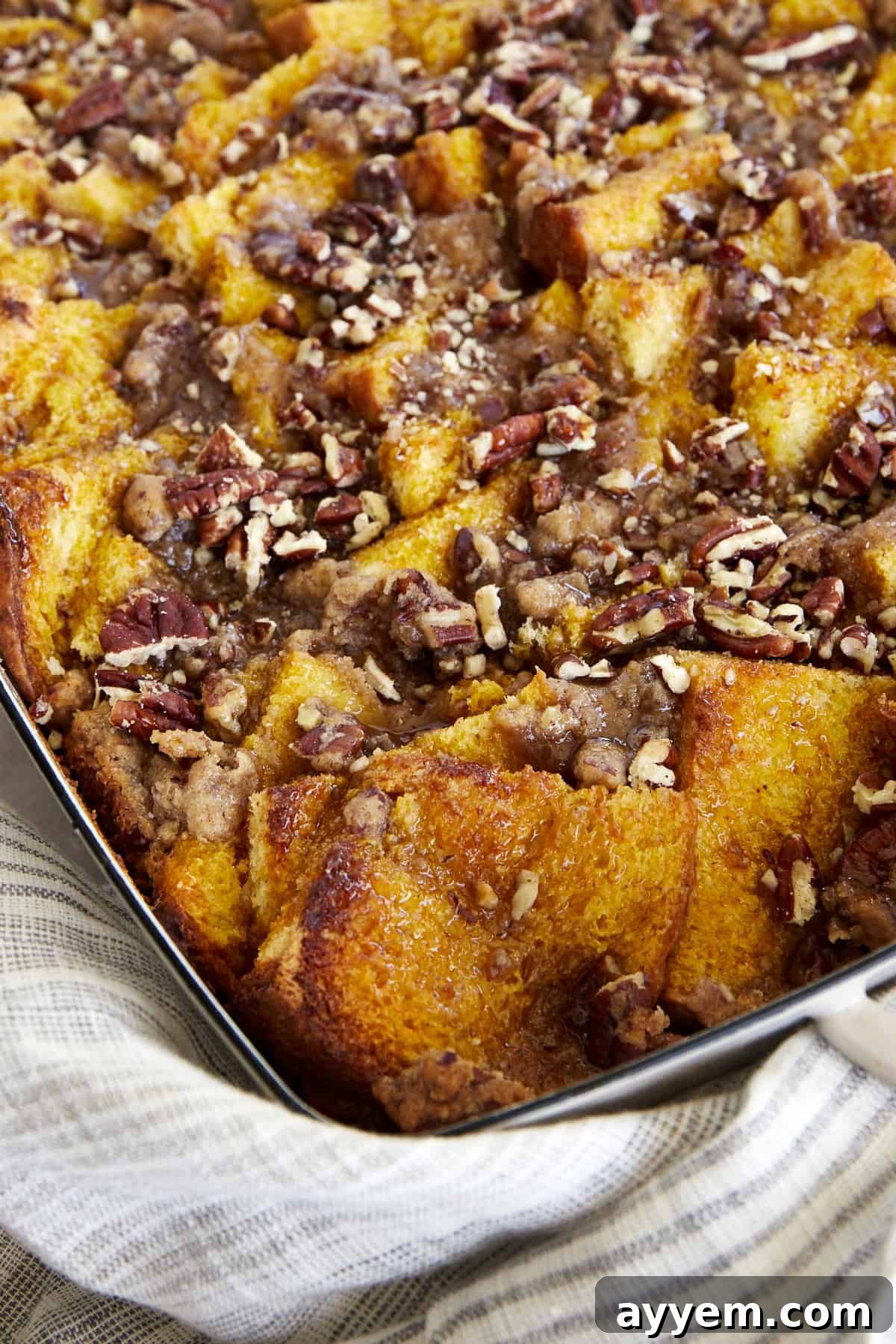 A top-down view of the rustic Pumpkin French Toast Casserole, garnished with fresh mint, ready to be served.