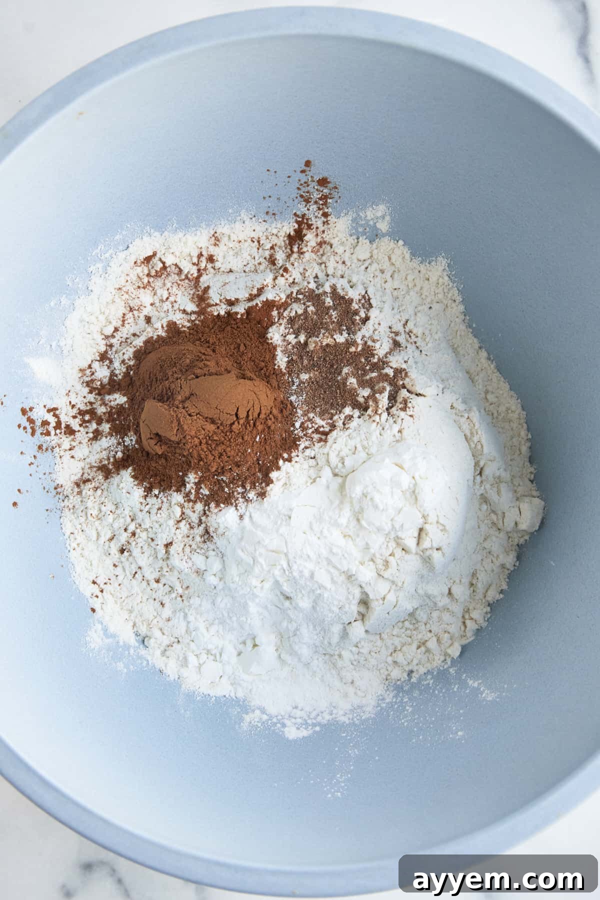 Flour, cornstarch, baking powder, and cinnamon in a bowl. 
