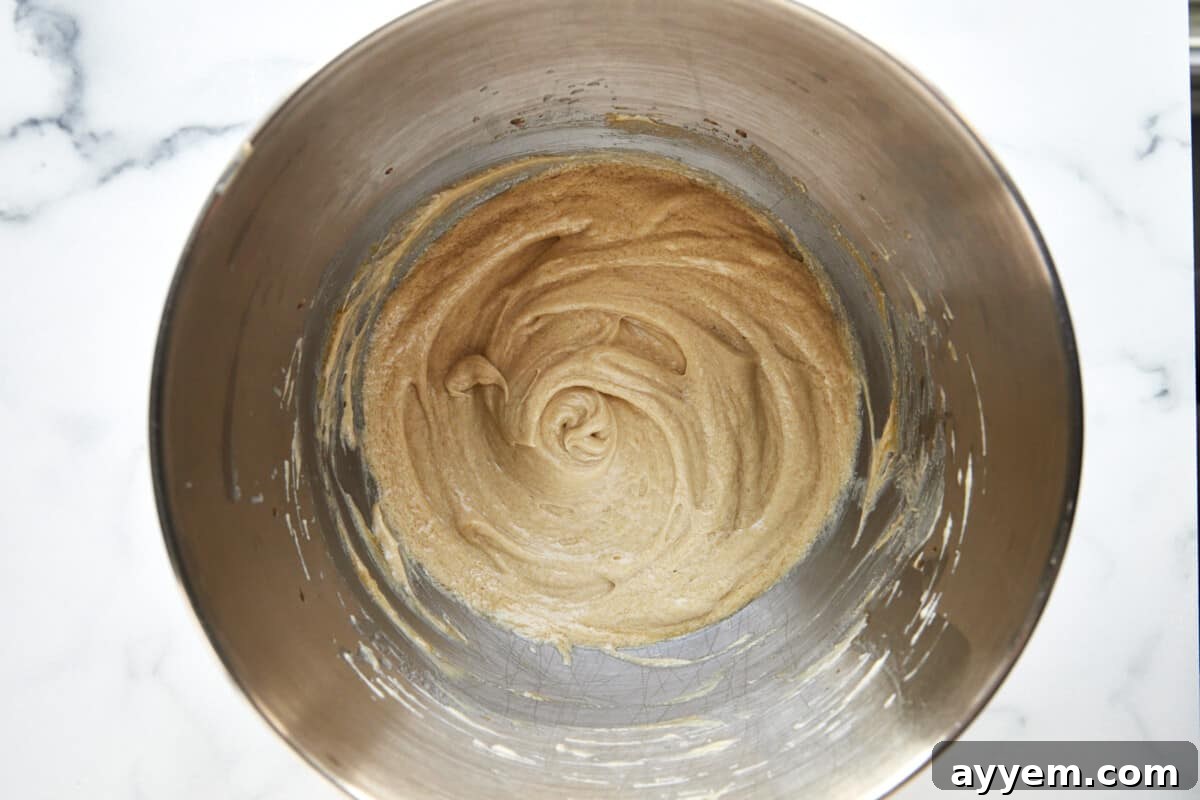 Combined wet ingredients for apple cider donuts in a bowl. 