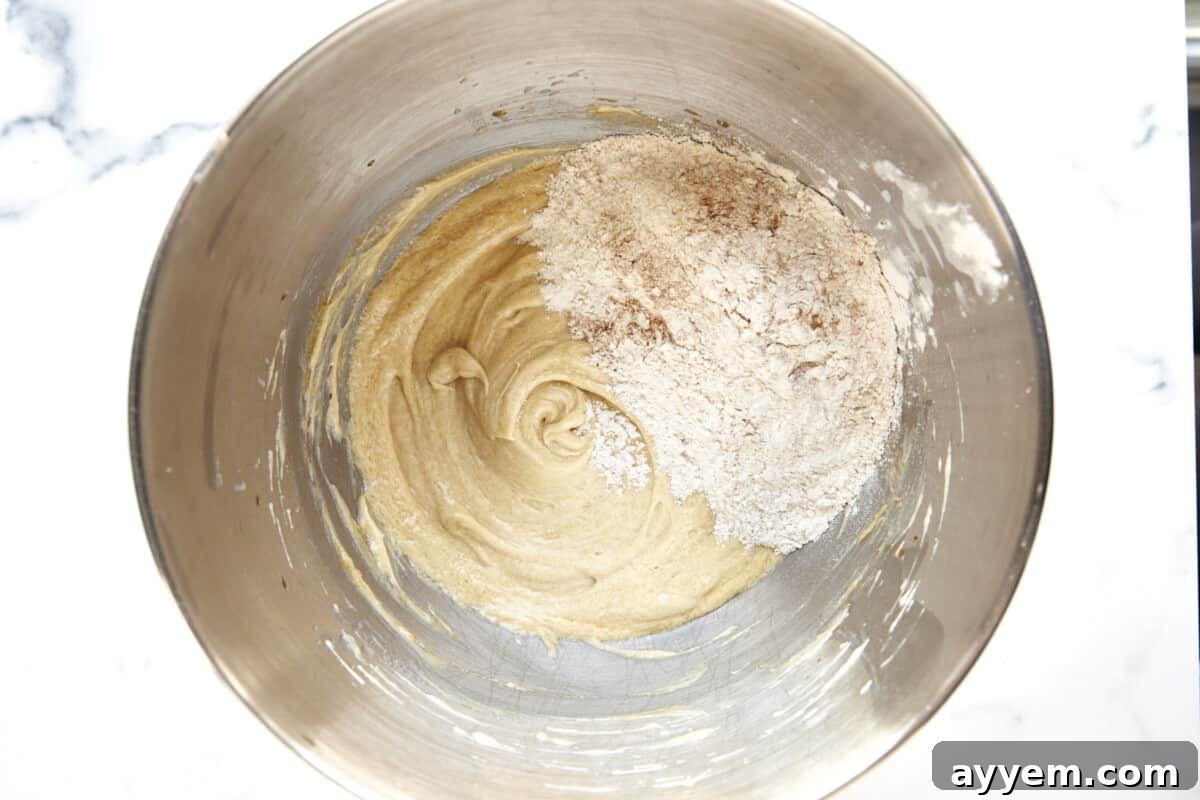Wet and dry ingredients for muffins being combined in a bowl. 