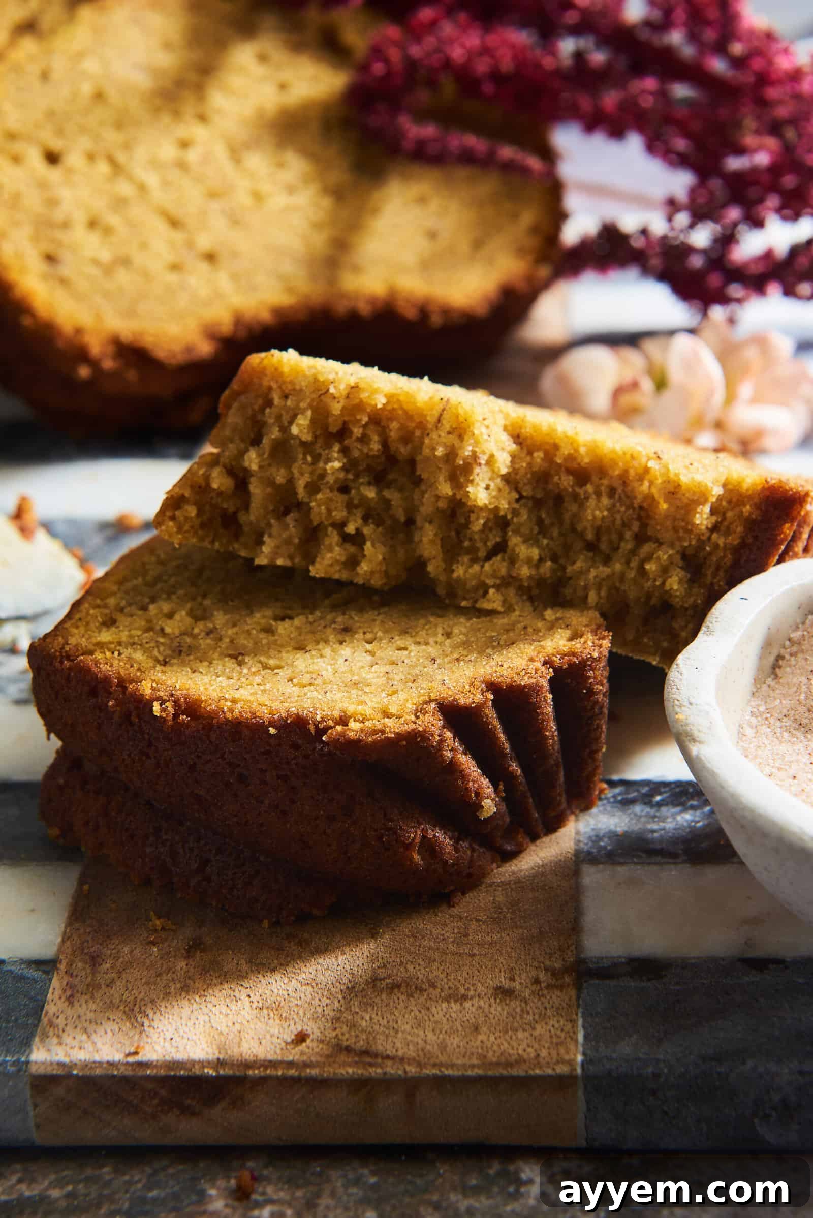 Two slices of moist pumpkin banana bread, perfectly baked and ready to be enjoyed.