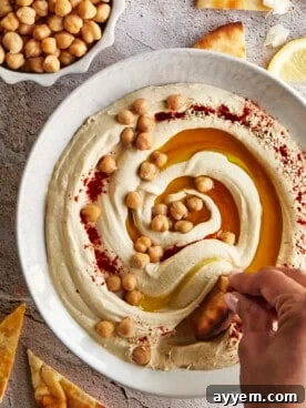 Creamy Healthy Chickpea Hummus served with fresh vegetables and pita bread, perfect for a light and wholesome meal.