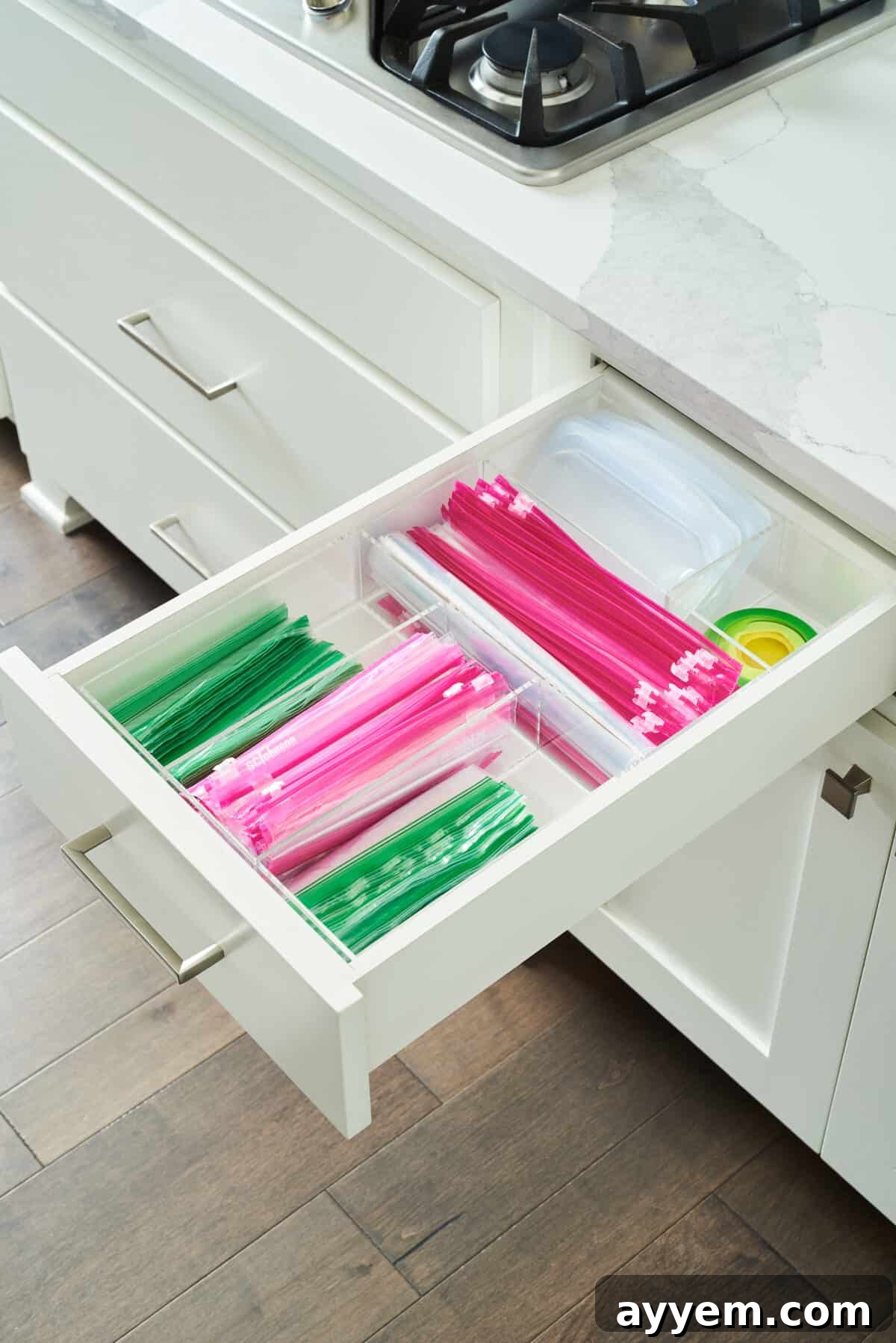 A kitchen drawer opened to reveal a perfectly organized assortment of bags and wraps, demonstrating effective use of storage solutions.