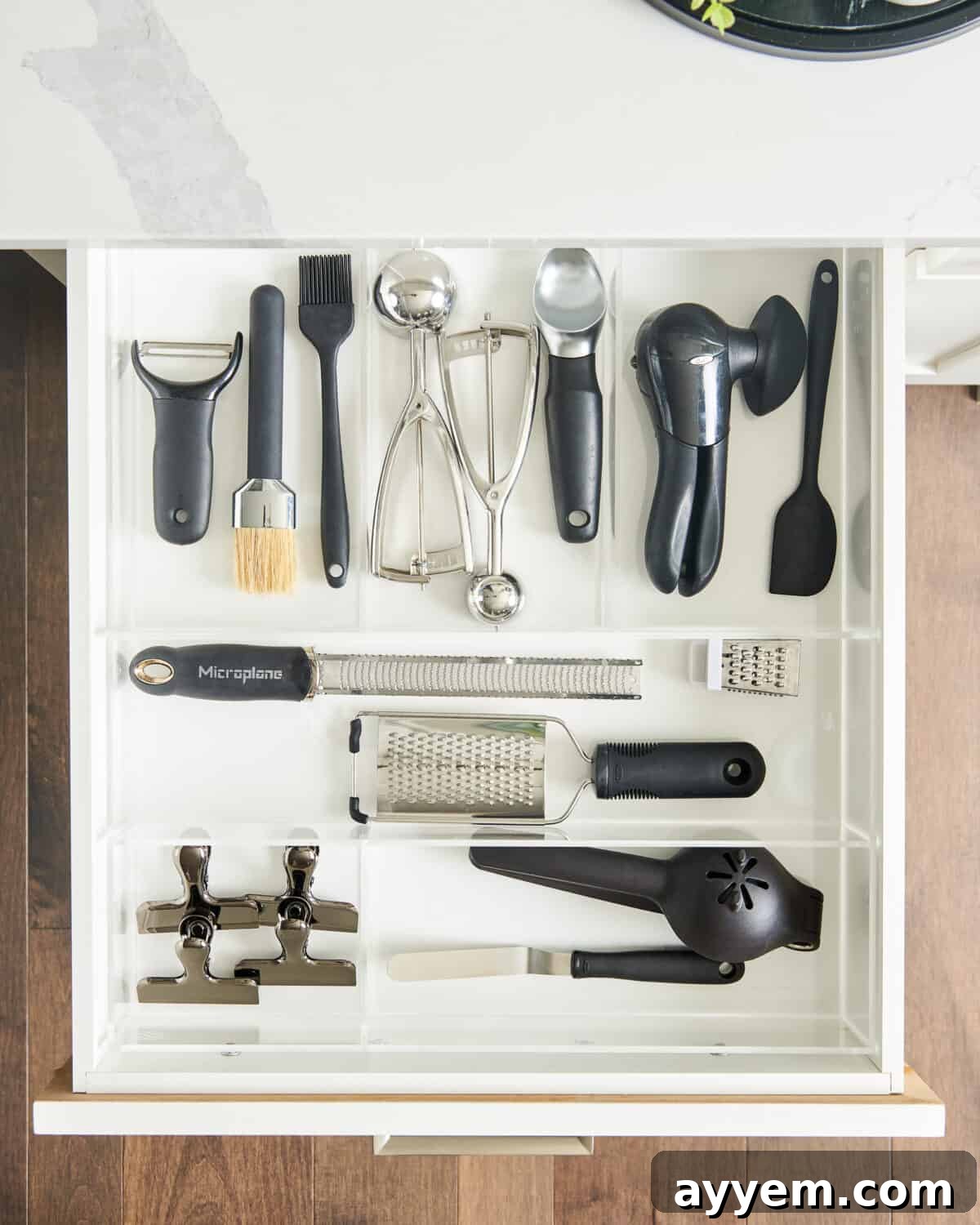 Organized kitchen tools neatly arranged in a drawer, showcasing efficient kitchen gadget organizers.