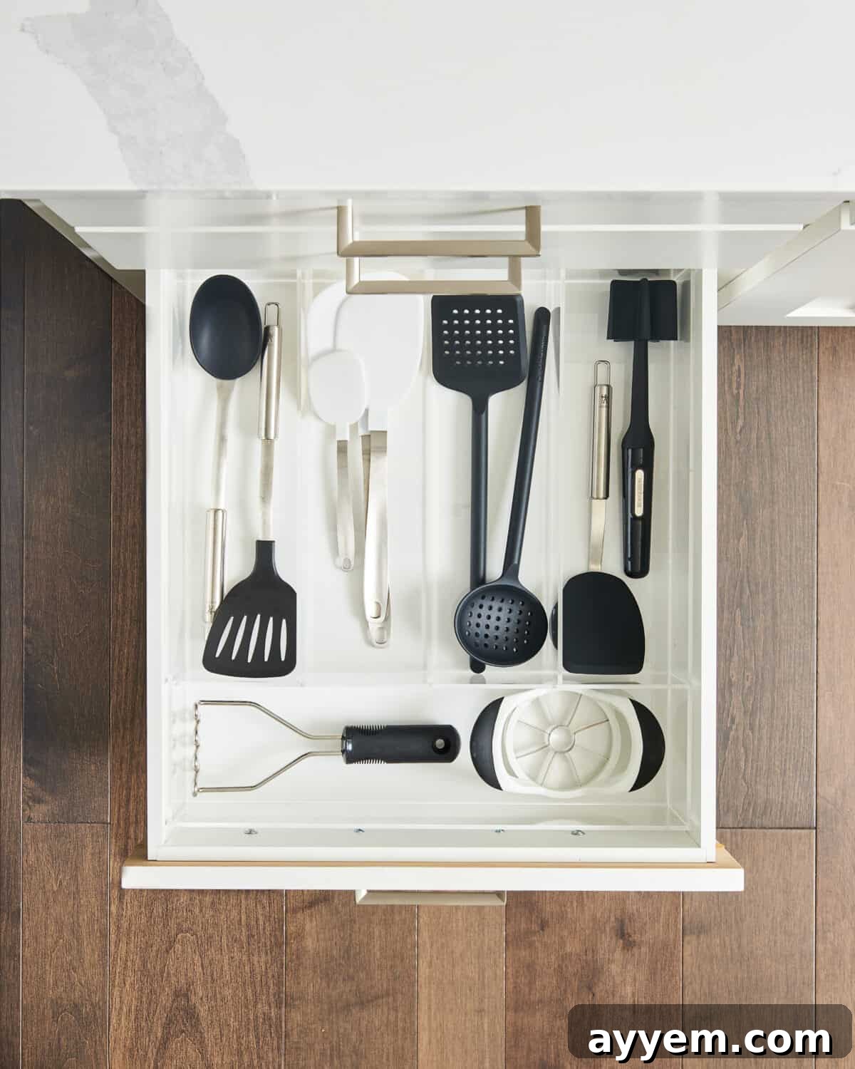 Various kitchen tools and utensils meticulously organized in a drawer, showcasing the efficiency of kitchen gadget organizers.