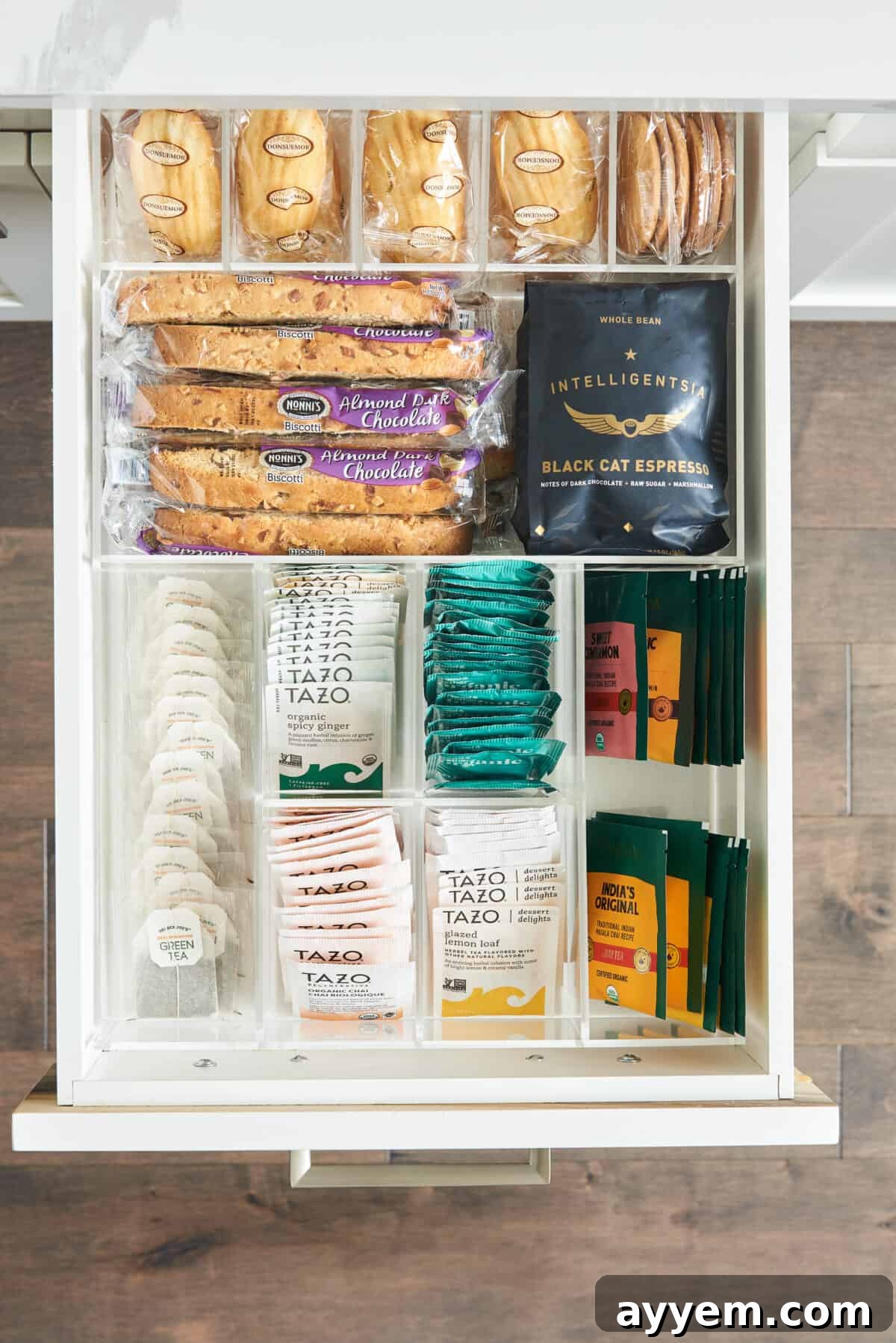 inside of drawer with storage holding tea, coffee, and snacks.
