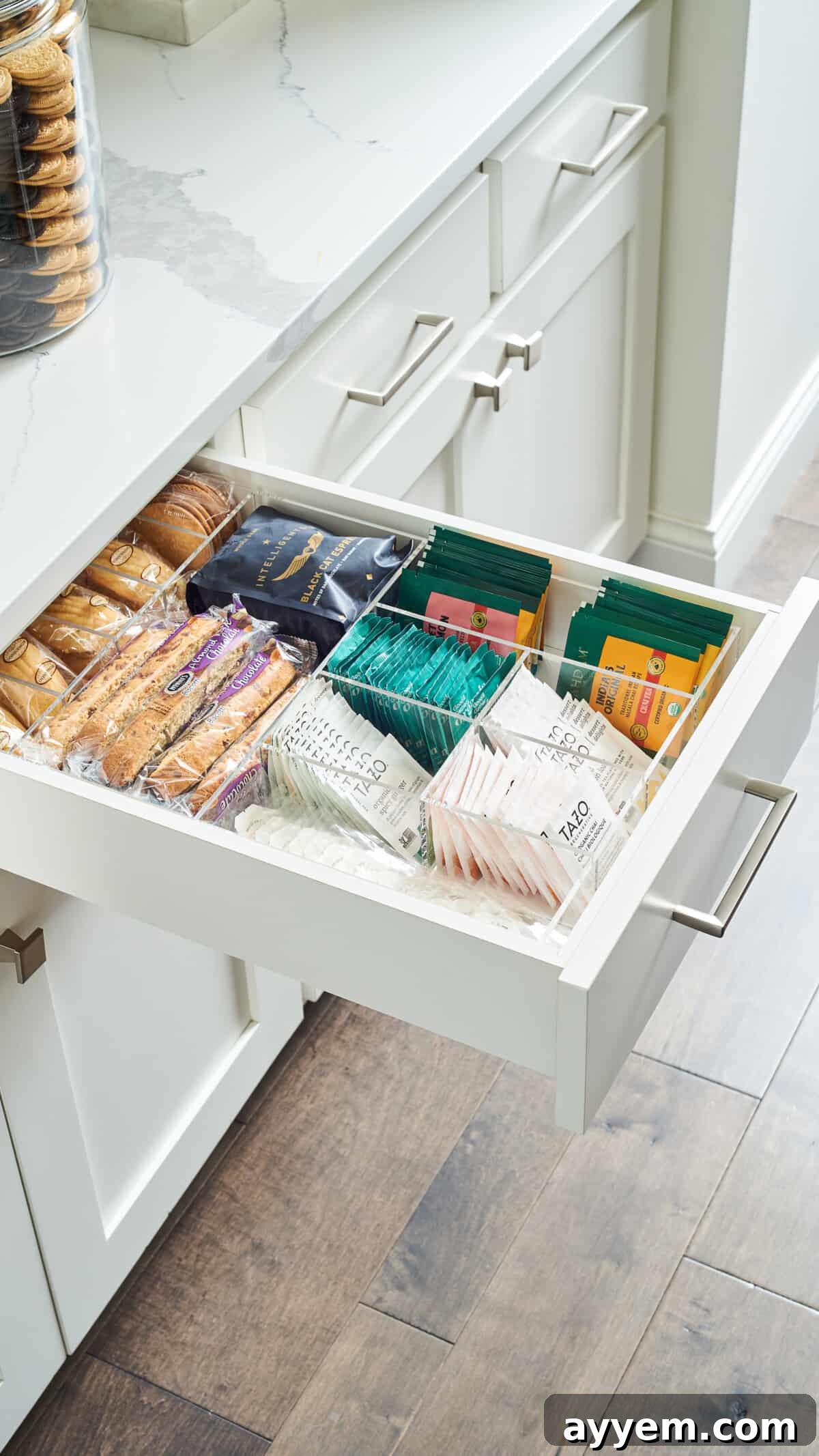 Open drawer with coffee, tea, and snacks.