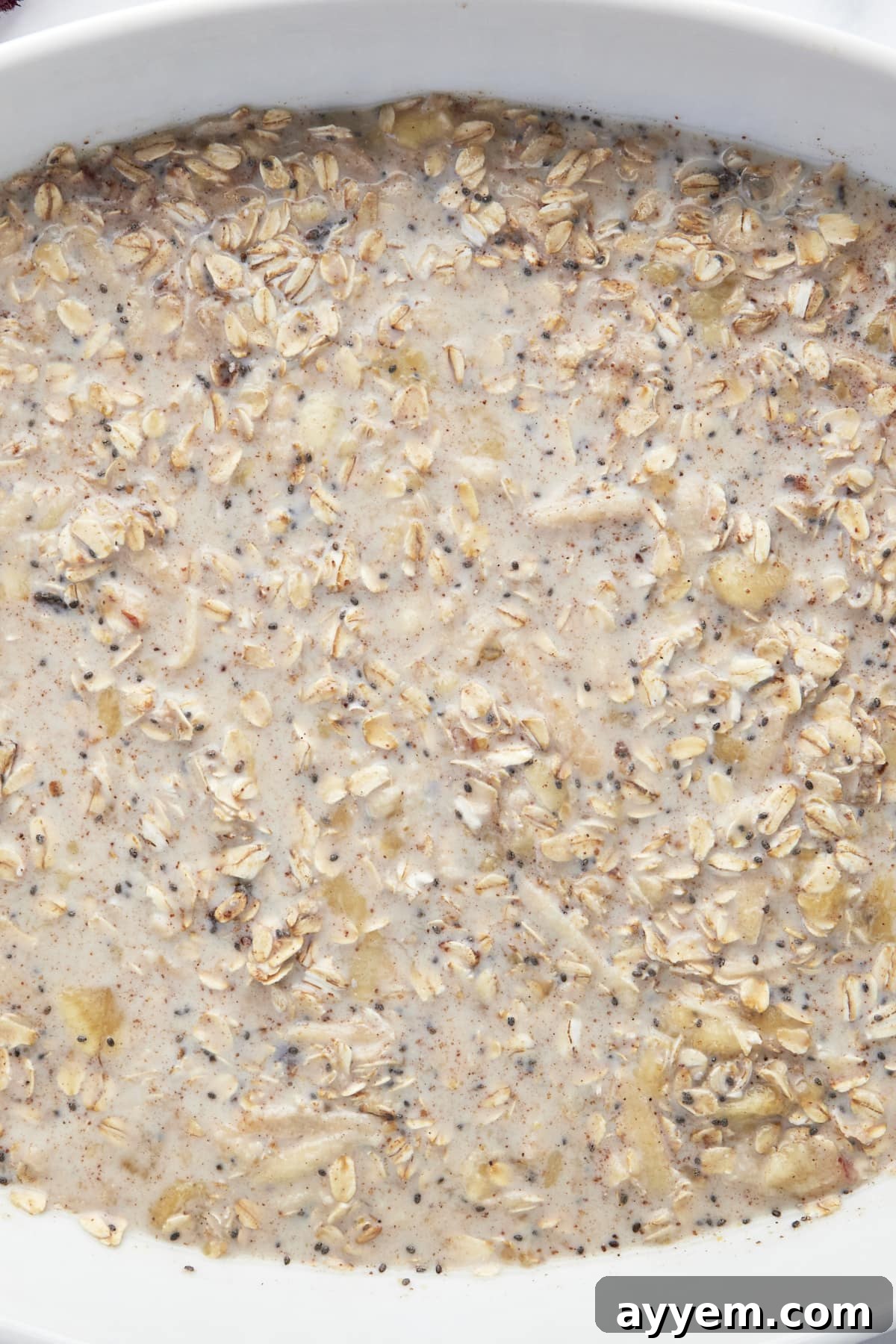 Unbaked ingredients for baked apple oatmeal in a baking dish. 