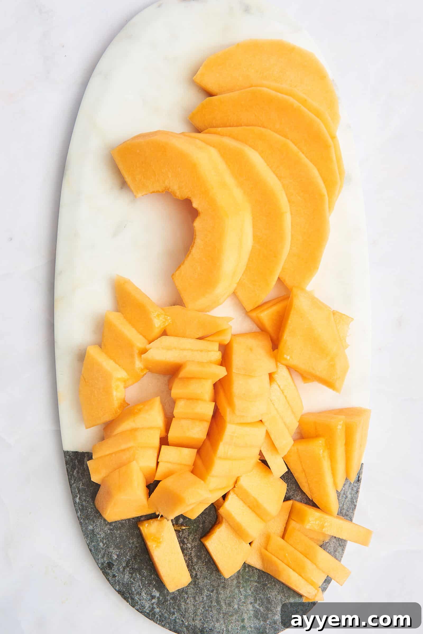A platter of sliced cantaloupe slices and cubes.