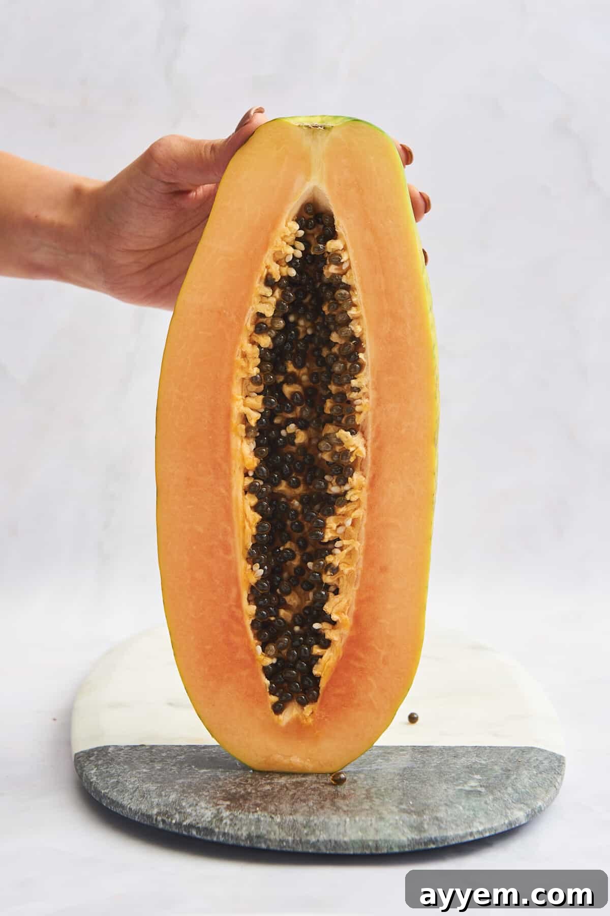 A halved papaya with black seeds in the center.